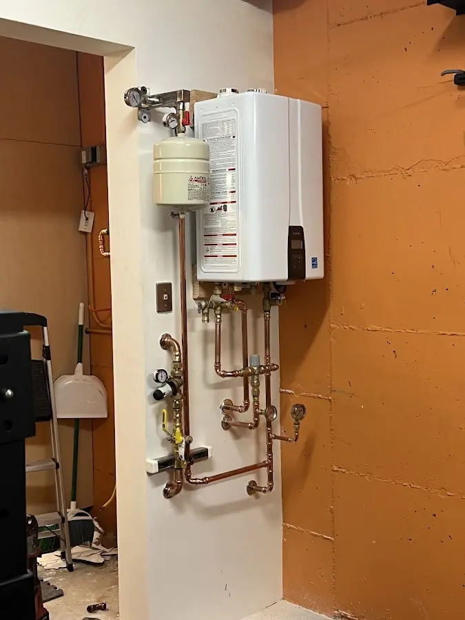 Plumbing technician inspecting water heater connections in Temecula